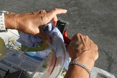 a man is pointing at something on the newspaper