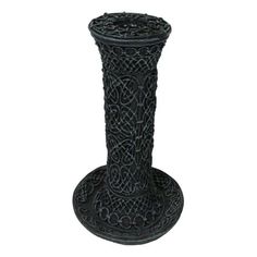 a black candle holder with an intricate design on the top and bottom, sitting on a white background