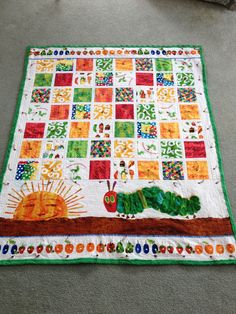 the very hungry caterpillar quilt on the floor