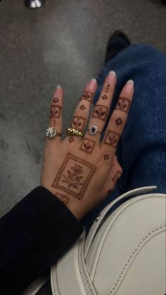 a woman's hand with tattoos on it