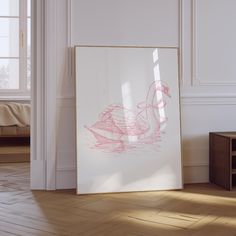 a white frame with a drawing of a duck on it sitting in front of a window