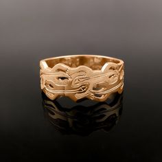 a gold ring sitting on top of a black surface