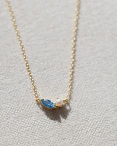 Crafted with 14k gold vermeil, this dainty necklace features a beautiful pearl paired with an ocean blue gemstone. The adjustable design allows for a perfect fit, making it a versatile and timeless piece for any occasion.  measures 16" at longest, 14" at shortest Blue Aesthetic Accessories, Gold Necklace Stack, Ocean Inspired Jewelry, Ocean Necklace, Pretty Jewelry Necklaces, Preppy Jewelry, Coastal Granddaughter, Ocean Jewelry, Jewelry Accessories Ideas