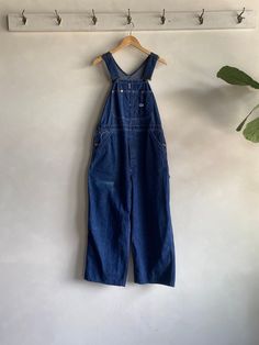 Amazing Vintage 50s/60s Lee Jelt Denim Dark Wash Overalls. Dark wash blue in color made from durable jelt denim (sanforized cotton) fibers. Button fly closure with a wide leg fit and adjustable shoulder straps. Condition overall is great with only minor flaws that include; a faded spot on front. There has been a small repair made on back as shown in photos. No rips, tears, or harsh staining. Please see all photos for details. Refer to measurements below to ensure a proper fit 38" waist 14" shoulder 26" inseam 56" in total length Wide Leg Overalls, Blue Overalls, Des Moines, Cotton Fiber, Shoulder Straps, Favorite Outfit, Overalls, Wide Leg, Bathing Beauties