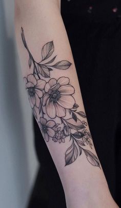 a woman's arm with flowers on it