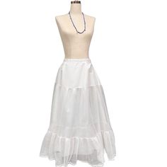 Add a touch of vintage charm to your wardrobe with this beautiful white crinoline petticoat skirt. Perfect for adding volume under dresses or as a stand-alone statement piece, this petticoat features a ruffle hem and a single-layer design with an overlay. The velcro-adjustable waistband ensures a comfortable fit. Please note light age coloring on some areas, adding to its vintage appeal. Size: Adjustable waist 13"-15" (Velcro)   Length: 34"   Material and care: Lightweight fabric with ruffle detail, gentle wash recommended   Condition: Good vintage condition with light age coloring vintage petticoat, white crinoline, ruffle hem skirt, vintage undergarment, bridal petticoat, retro fashion, classic petticoat, voluminous skirt, 1950s style, adjustable waist petticoat, vintage accessories, sta White Ruffle Skirt, Skirt With Ruffle Hem, Petticoat Skirt, Voluminous Skirt, Ruffle Hem Skirt, Statement Skirt, 1950s Style, Skirt Vintage, Layer Design