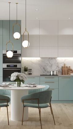 a kitchen with blue cabinets and marble counter tops, two round dining tables surrounded by chairs