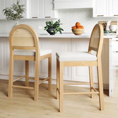 two wooden chairs sitting next to each other on top of a hard wood floored kitchen