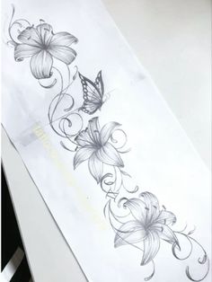 a white tie with flowers on it and a butterfly flying over the top of it