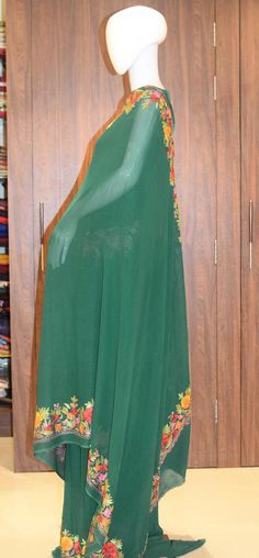 A Marvellous Embroidered Kashmiri Saree which you can wear at any party or a wedding.- - - - - - - - - - - - - - - - - - - - Product DetailsCondition: Brand NewEmbroidery: Kashmiri Aari embroideryColour: GreenF A B R I CSaree: Viscose Georgette Blouse: Indian CrepeF I N I S H- UnstitchedYou can get it stitched locally.- StitchedWant your blouse ready to wear, let us know the style you want and we will stitch it for you.***PLEASE NOTE: We would require you to share certain precise body measuremen Floor-length Traditional Wear With Resham Embroidery For Ceremonies, Floor-length Traditional Wear With Resham Embroidery, Semi-stitched Maxi Length Dupatta With Floral Embroidery, Semi-stitched Floral Embroidery Salwar Kameez Floor-length, Semi-stitched Floor-length Salwar Kameez With Floral Embroidery, Floor-length Salwar Kameez With Floral Embroidery, Semi-stitched, Traditional Wear With Resham Embroidery In Maxi Length, Floor-length Embroidered Chinon Kurta, Designer Floor-length Dupatta With Floral Embroidery