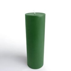 a green pillar candle on a white background