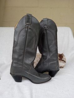 Justin gray ladies boots with 2 in. heel and tall shaft. Size 6 B. They are in good condition. They have a 13 3/4 in tall narrow leg,  Please look at photographs. Gray Formal Boots For Fall, Formal Gray Boots For Fall, Extra Tall Cowboy Boots, Gray Western Boots For Fall, Tall Black Cowboy Boots, Luxury Vintage Cowboy Boots With Plain Toe, Womens Justin Cowboy Boots, Justin Cowgirl Boots, Western Boots Women