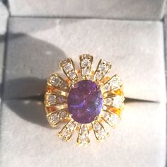 an amethorate ring in a box with diamonds