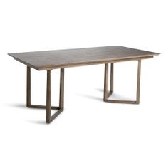 a wooden table sitting on top of a white floor next to a metal frame structure