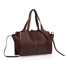 For the chic, simple woman with a love for understated luxury, the Celine Trifold bag is a true must-have. Carefully crafted from smooth leather in an aubergine hue, the Trifold is the ultimate every day go-to. Spacious enough to comfortably hold all your essentials, this stunning piece is also the perfect balance between fashion and function. Discreet and modest, the Trifold is intriguing due to its low-key glamorous style and timeless silhouette. Exuding a true "if you know, you know" aesthetic, the Trifold is a well worthy addition to any luxury handbag collection. Sleek, stylish and sophisticated, this gorgeous bag is one you won't regret purchasing.?ÿ SPL Exterior  Aubergine smooth leather Silver tone hardware Two top handles Celine embossed leather logo Zip close Two leather side tag Celine Trifold Bag, Leather Aesthetic, Bag Leather Women, Simple Leather Bag, Simple Woman, Designer Leather Handbags, Tas Fashion, Folding Bag, Handbag Collection