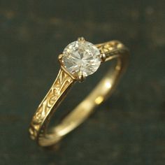 a gold ring with a diamond in the center