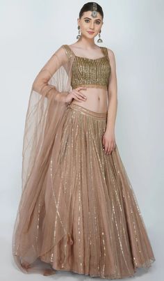 Gold Organza Pre-draped Saree For Navratri, Glamorous Semi-stitched Lehenga With Sheer Dupatta, Glamorous Hand Embellished Organza Lehenga, Glamorous Georgette Lehenga For Reception, Glamorous Reception Georgette Lehenga, Festive Hand Embellished Organza Pre-draped Saree, Glamorous Georgette Anarkali Set For Reception, Hand Embellished Tissue Silk Lehenga For Eid, Glamorous Floor-length Lehenga With Sheer Dupatta