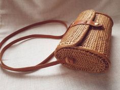 Wicker handbag, brown round rattan bag. Hand woven rattan across the body shoulder bag. From Bali. Womens summer Hand bag made from ata grass. Summer bag style 2020Our most popular andStylish summer time bag for all your treasures.Step into summer with this handwoven ata grass bag. Lined with  cotton. This handwoven purse with leather shoulder strap is the perfect accent for a summer dress or any casual look ♡Size20cm x 12cm x 7cm♡Strong and durable.♡Leather shoulder strap is 60cm in length.♡Lin Rattan Handbags, Wicker Purse, Soul Design, Rattan Bag, Woven Rattan, Summer Bag, Bag Style, Shoulder Purse, Hand Bag