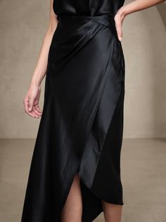 Draping delight, this soft and smooth skirt is crafted from indulgent silk charmeuse, a luxurious fabrication and an ideal choice enhanced by bias-cut construction, giving the illusion of elongated legs (and even more drape).  COLUMN FIT: Semi-fitted Silk Lined Draped Skirt, Silk Asymmetrical Skirt For Formal Occasions, Pre-draped Asymmetrical Skirt For Evening, Formal Bias Cut Relaxed Skirt, Elegant Bias Cut Asymmetrical Skirt, Elegant Asymmetrical Bias Cut Skirt, Elegant Satin Skirt For Gala, Silk Lined Skirt For Gala, Lined Satin Skirt For Evening