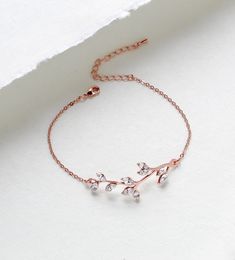 So lovely and delicate.  I created this bracelet in rose gold finish with Premium European crystals.  A romantic leaf design perfect for weddings or everyday.   Bracelet pictured measures 6 inches and extends to 8 inches. Bracelet is .5 inch wide. PLEASE ALLOW APPROX 7 BUSINESS DAYS FOR COMPLETION BEFORE SHIPPING This is an original design by © Treasures by Agnes MATCHING PIECES: https://www.etsy.com/listing/485297202/bridesmaid-necklace-rose-gold-necklace?ref=shop_home_active_2 https://www.etsy.com/listing/511298012/rose-gold-earrings-crystal-bridal Feel free to contact me with any questions !  Thank you for visiting ! Treasures570  Back to main page of Treasures570 for more beautiful designs https://www.etsy.com/shop/treasures570?ref=hdr_shop_menu All pieces come beautifully gift wrapped Delicate Rose Gold Cubic Zirconia Bracelets, Delicate Rose Gold Bangle Chain Bracelet, Elegant Gold Crystal Bracelet As Bridesmaid Gift, Dainty Rose Gold Bracelets For Wedding, Dainty Rose Gold Diamond Bangle Bracelet, Elegant Rose Gold Chain Bracelet For Wedding, Elegant Gold Crystal Bracelet For Bridesmaids, Dainty Rose Gold Chain Bracelet For Anniversary, Minimalist Rose Gold Bracelets For Wedding