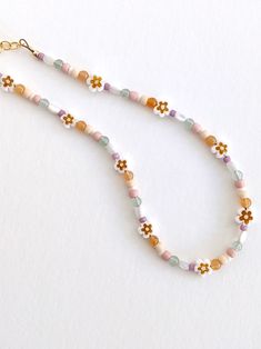 The perfect spring necklace 🌼 Choker style Gold-filled chain, clasp, & extender Intended for ages 2 years & up. Playful Handmade Beaded Bracelets For Spring, Casual Beaded Necklaces For Spring Gift, Casual Beaded Necklace For Spring Season Gift, Casual Flower-shaped Beaded Necklaces, Bohemian Beaded Bracelets For Everyday Spring Wear, Bohemian Beaded Bracelets For Spring, Casual Beaded Bracelets With Round Beads For Spring, Playful White Beaded Necklaces For Summer, White Playful Beaded Necklaces For Summer