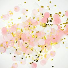 pink and gold confetti sprinkles against a white background