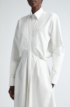 A tried-and-true silhouette evolves into a statement piece thanks to sophisticated tailoring with body-skimming waistline darts that cinch this maxi shirtdress. 51" length (size 8) Hidden-button placket Point collar Long sleeves with one-button cuffs Side-seam pockets 100% cotton Dry clean Made in the USA Designer Clothing