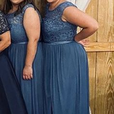 three women in blue dresses standing next to each other