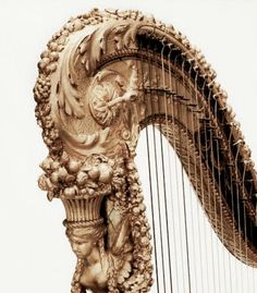 an elaborately decorated golden harp against a white sky