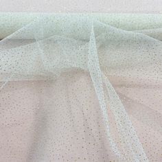 Introducing Glitter Mesh Fabric from Lace USA, an exquisite and high-quality fabric perfect for adding a touch of sparkle and elegance to your wardrobe. Perfect for wedding dresses, evening dresses, quinceanera dresses, and dance costumes, this fabric will make you feel like royalty. Made from 100% polyester and measuring approximately 60 inches wide, this beautiful fabric is available in 25 unique colors, each of which provides a unique blend of glitter and shimmer. Although some of the glitter Champagne Glitter Sequin Fabric For Wedding, Elegant Sequin Fabric With Shimmer For Weddings, Elegant Wedding Sequin Fabric With Shimmer, Elegant Sparkling Tulle Fabric For Wedding, White Shimmer Sequin Fabric For Wedding, Elegant Sparkling Glitter Tulle Sequin Fabric, Elegant Evening Glitter Tulle Sequin Fabric, Elegant Evening Sequin Glitter Tulle Fabric, Elegant Sparkling Tulle Fabric For Party