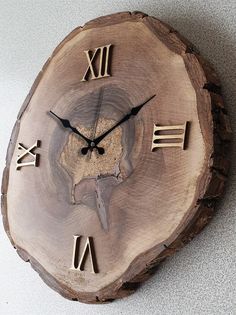 a wooden clock with roman numerals on the face is shown in this image