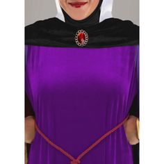 a woman wearing a purple dress with a red brooch on it's neck