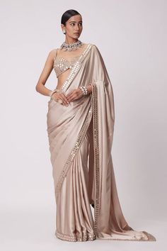 Beige satin saree with a mirror embroidered border. Paired with a padded mirror embroidered blouse. - Aza Fashions Festive Satin Pre-draped Saree, Elegant Pre-draped Saree With Gota Work, Designer Traditional Wear With Resham Embroidery On Satin, Bollywood Silk Saree For Reception, Semi-stitched Satin Blouse Piece With Resham Embroidery, Elegant Pre-draped Saree With Gota Work In Dola Silk, Fitted Satin Saree For Designer Wear, Satin Pre-draped Saree With Pallu For Wedding, Fitted Satin Blouse Piece With Dupatta