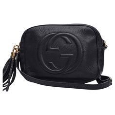 This crossbody bag is made of pebbled calfskin leather in black, with a prominent Gucci GG logo stitched on the front. The bag features an adjustable leather shoulder strap with polished gold hardware. The matching gold-knobbed leather tassel zipper pulls open to a black nylon with enough room for basic essentials. Color: Black Material: Leather Serial code: 308364 Model No.: 308364 Measures: H 6.5” x L 8.5” x D 3" Comes with: No brand dust bag Condition: Good. Faint marks to leather and interio Black Gucci Crossbody Bag, Gucci Sling Bag, Gucci Sling, Soho Disco Bag, Sling Bag Black, Basic Essentials, Gucci Crossbody Bag, Gucci Soho Disco, Gucci Crossbody