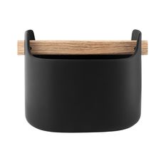 a black container with a wooden handle on the top and bottom, against a white background