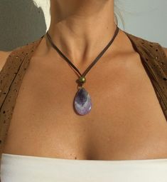 "Amethyst Pendant Necklace for Women, Amethyst Gemstone Necklace, Leather Necklace, Natural Stone Necklace belong to gemstone jewelry as well as boho jewelry carefully designed and crafted by EndiaDesign. Show off a boho style with this unique necklace for women made of high quality cow leather, an amethyst (tiger eye, pink quartz or aventurine) gem pendant and beads in antique bronze tone. Amethyst Healing Properties ♥ Increases nobility ♥ Spiritual awareness ♥ Psychic abilities ♥ Inner peace a Purple Necklace With Large Stone For Gift, Adjustable Crystal Necklace With Natural Stones, Purple Gemstone Bead Pendant Jewelry, Purple Pendant Jewelry With Gemstone Beads, Adjustable Gemstone Drop Necklace Gift, Unique Adjustable Amethyst Necklaces, Adjustable Crystal Necklace With Large Stone As Gift, Adjustable Drop Necklace With Natural Stones As Gift, Adjustable Drop Necklace With Natural Stones For Gift