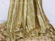 Beige Indian Jacquard Dress Material Brocade Wedding Dress Fabric By The Yard Crafting Sewing Silk Curtains Making Duvet Cover Bridal Dresses. Tanchoi Banarsi Brocade Fabric. This is a beautiful jacquard floral design fabric in Beige color. ➤ Fabric Type: Blended Silk (Viscose & Silk Satin) ➤ Color: Beige, Pink, Lime Green and Gold. ➤ Code: bg2251 ➤ Width of the fabric is 44 inches. ➤ Listing for 1 Yard of fabric. ➤ Care: Dry Clean Only You can use this fabric to make Dresses, Tops, Blouses, Green Brocade Dress For Wedding, Green Brocade Wedding Dress, Gold Jacquard Dresses For Wedding, Gold Jacquard Wedding Dress, Pink Jacquard Dress For Wedding, Gold Fitted Brocade Fabric, Elegant Green Fabric For Wedding, Pink Brocade Fabric For Wedding, Elegant Jacquard Fabric For Wedding