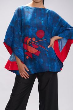 Blue blended silk poncho with print and embroidered pattern.
Components:1
Pattern:Printed, Embroidered
Neckline:Round
Sleeve Type:Three quarter
Fabric:Blended silk 
Color:Blue
Other Details:
Cape style sleeves
Note : Pant worn by the model is not for sale.
Occasion:Work - Aza Fashions Traditional Blue Batik Print Tops, Traditional Blue Blouse With Printed Motifs, Blue Bohemian Top With Kimono Sleeves, Bohemian Blue Blouse With Printed Motifs, Blue Bohemian Blouse With Batik Print, Blue Bohemian Blouse With Printed Motifs, Blue Bohemian Tops With Printed Motifs, Blue Tunic With Kimono Sleeves, Blue Tunic With Kimono Sleeves For Spring