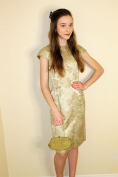 This "Dynasty" brand original is a stunning shimmering Damask  fitted Asian inspired fitted Vintage cocktail dress. This is a vintage piece from the 1960s. Color is between soft metallic silver (slight green hue) with embroidered flower and leaf design. In Very good condition (very slight tear in fabric under left arm, barely visible while wearing, easy fix) . Unsure of fabric, Label says dry clean only, and stated its a size 8 , but really fits a current size 4 , small waist. Message me for exa Retro Fitted Mini Dress For Cocktails, 1950s Style Knee-length Party Dress, Retro Knee-length Vintage Dress For Party, Elegant Fitted Vintage Party Dress, Elegant Fitted Vintage Dress For Party, 1950s Style Fitted Party Dress, Chic Fitted Vintage Dress For Formal Occasions, Chic Formal Fitted Vintage Dress, Chic Vintage Fitted Dress For Formal Occasions