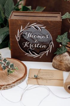 a wooden box sitting on top of a table next to some paper and twine