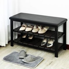 there is a shoe rack with several pairs of shoes on it next to a pair of slippers