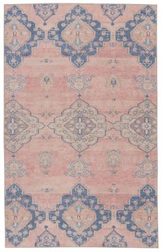 an antique rug with blue and pink colors