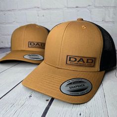 the dad trucker hat is tan and black