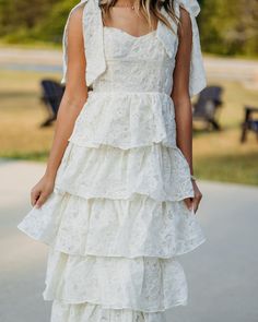 Floral embroidered tiered midi dress -lined -non-sheer -Lightweight -Fabric content - 100% polyester -Colors may vary from different viewing devices. Lace Tiered Skirt Maxi Dress For Summer, Layered Spring Wedding Dress, Elegant Layered Midi Dress, Tiered Lace Summer Wedding Dress, Summer Wedding Dress With Layered Hem, Tiered Lace Wedding Dress For Summer, Summer Wedding Tiered Lace Dress, Feminine Tiered Lace Midi Dress, Tiered Midi Dress With Ruffles For Wedding