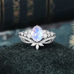 a ring with an oval stone surrounded by diamonds