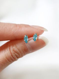 Tiny marquis stud earrings in a vibrant sky blue, also the birthstone for the month of December. Hand set faceted pinched oval cubic zirconia subtly catch the light.  Hardware has been tumble polished for hours to achieve a satin finish, butterfly backings.  Packaged in a beautiful gift box.Perfect for standard lobe piercings and make great stacking pieces for 2nd and 3rd piercings (shown worn in the last photo, paired with our micro star studs https://www.etsy.com/listing/706430537/  ).MATERIAL Dainty Marquise Earrings As Gift, Dainty Marquise-cut Jewelry As A Gift, Dainty Marquise Cut Jewelry For Gifts, Marquise Cut Birthstone Jewelry Gift, Dainty Marquise Cut Jewelry As Gift, Gift Sterling Silver Marquise Cut Earrings, Blue Marquise Cut Jewelry For Gift, 3rd Piercings, Lobe Piercings