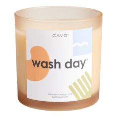 a candle that says wash day on the front and back of it, with an orange circle