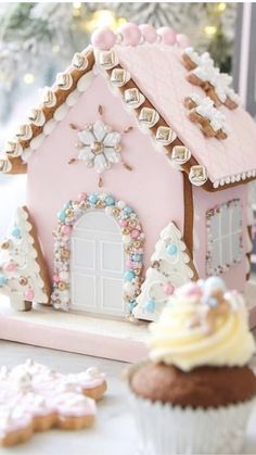 a pink gingerbread house on a table