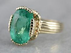 This vintage emerald ring is a simple, and quite a versatile piece with clean lines and great proportions. This ring is classic and traditional, featuring a solid gold head to hold the stone securely. The beautiful emerald has a shade of green that is just the same as the brightest springtime leaves. Metal: 14K Yellow Gold Gem: Emerald 4.08 Carats Gem Measurements: 12.1 x 8.5 mm, Oval Ring Size: 6 Marks: "KIMBERLY 14K" Stamped on the inside band Vintage Emerald Ring, Emerald Ring Vintage, Sapphire Solitaire Ring, Right Hand Ring, Sapphire Solitaire, Ring Emerald, Right Hand Rings, Hand Ring, Oval Ring