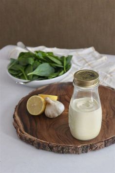 a jar of milk sitting on top of a wooden plate